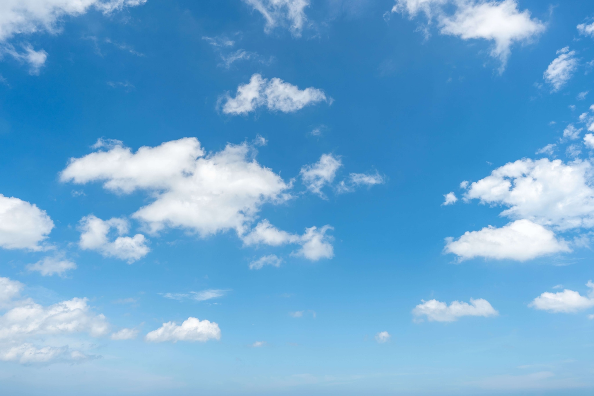 White clouds scattered across a blue sky