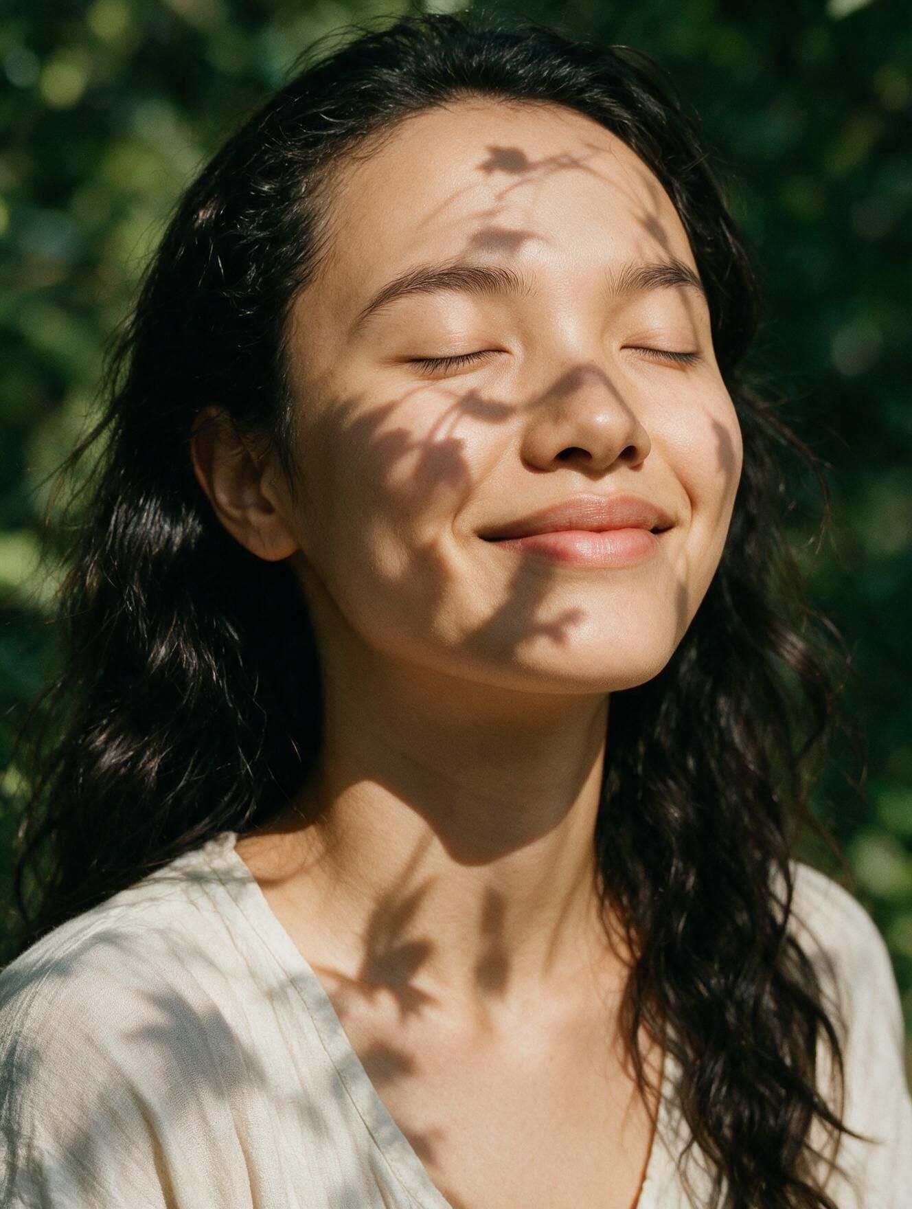 young woman with a smile and eyes closed