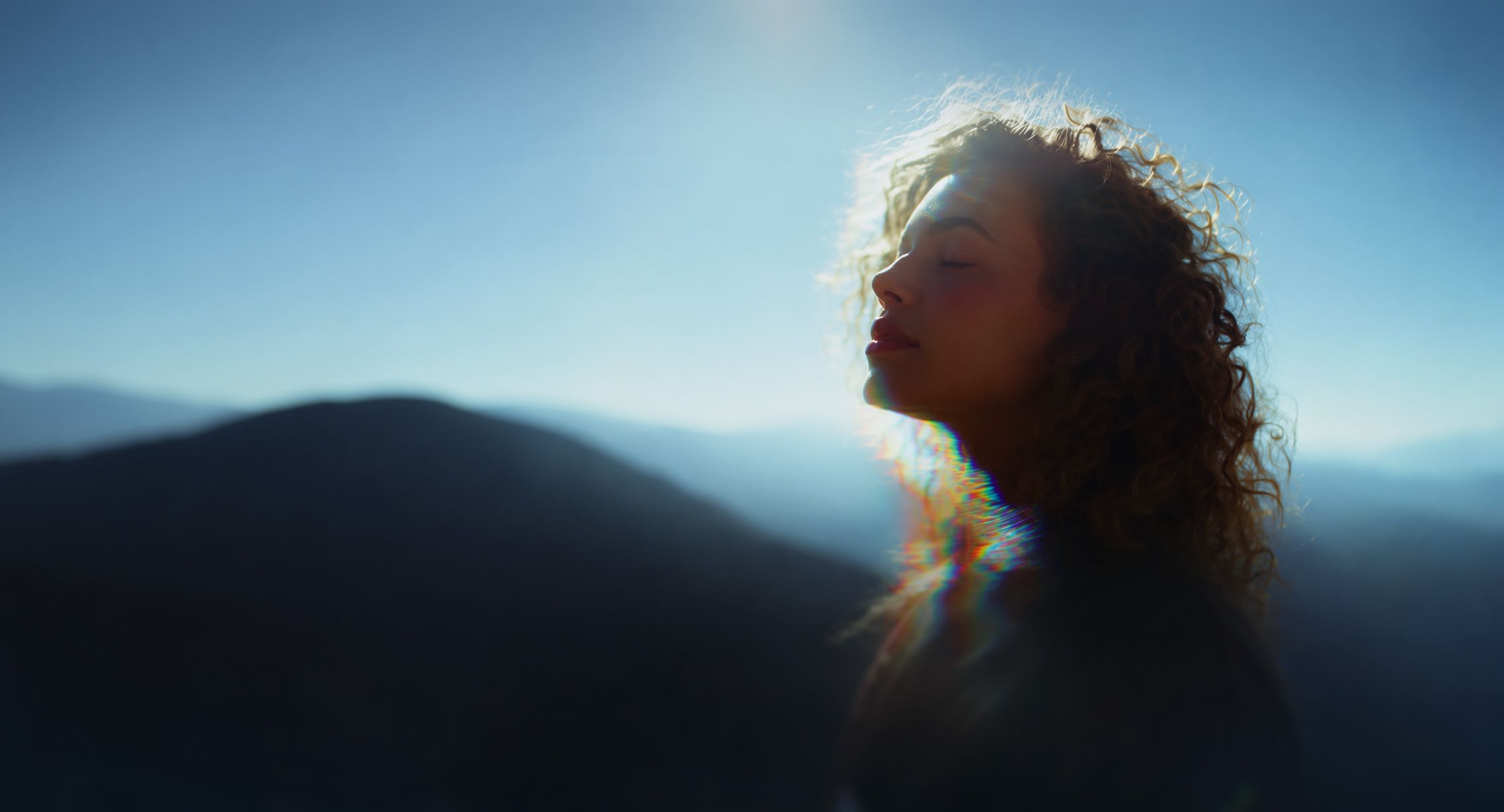 A patient standing against a mountain in the background symbolizing overcoming challenging obstacles
